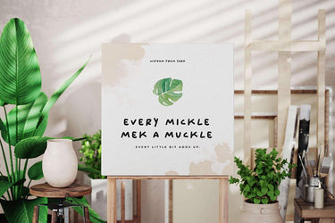 Canvas mockup hanging in a leafy, plant-filled corner of a room with natural lighting, evoking tropical home decor.
